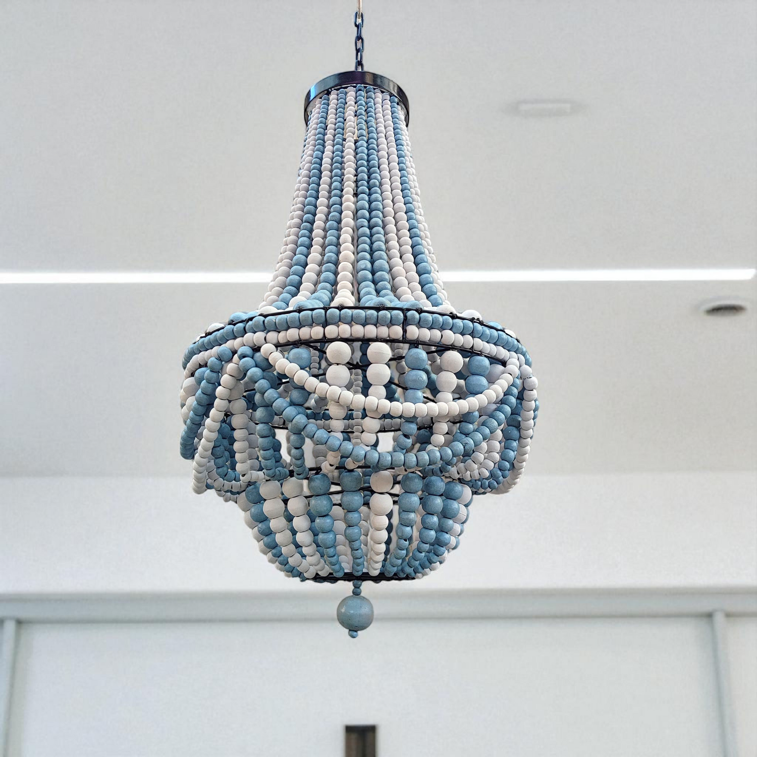 blue coastal color beaded chandelier hanging on the ceiling