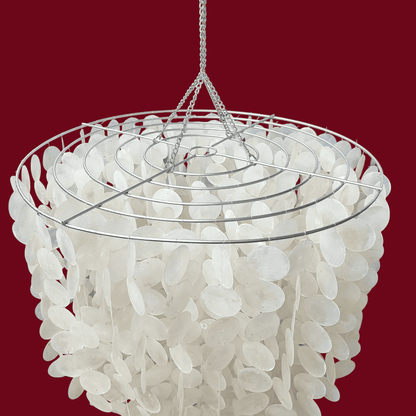 Chandelier with white capiz shell design on a red background
