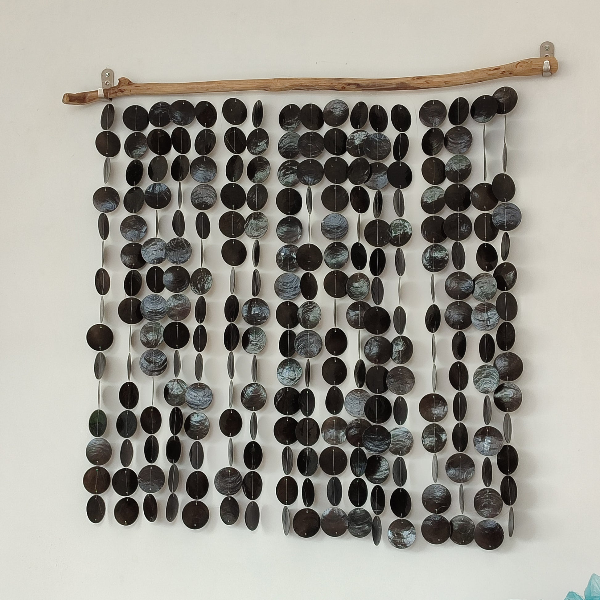 Wall art made of black capiz shell on a white background