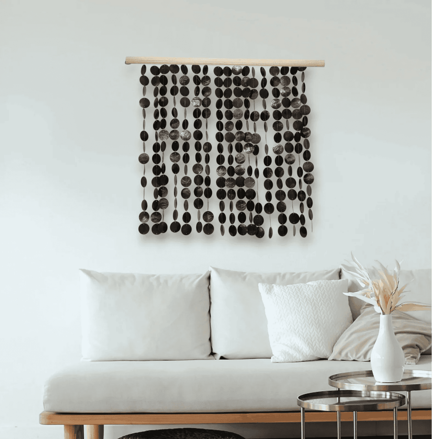 Decorative capiz shell wall hanging above a sofa in a living room