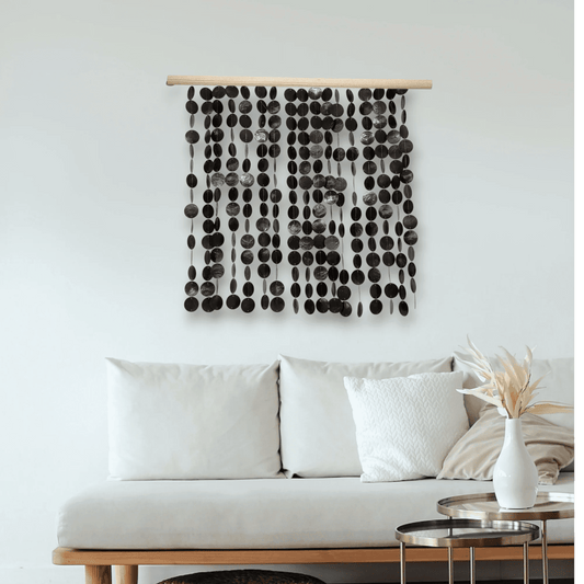 Decorative capiz shell wall hanging above a sofa in a living room