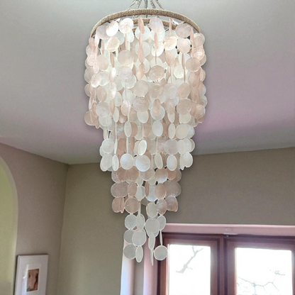 Chandelier made of capiz shell hanging from a ceiling.