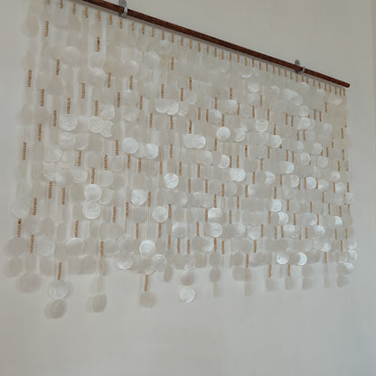 White capiz shell wall decor hanging on the wall from left side