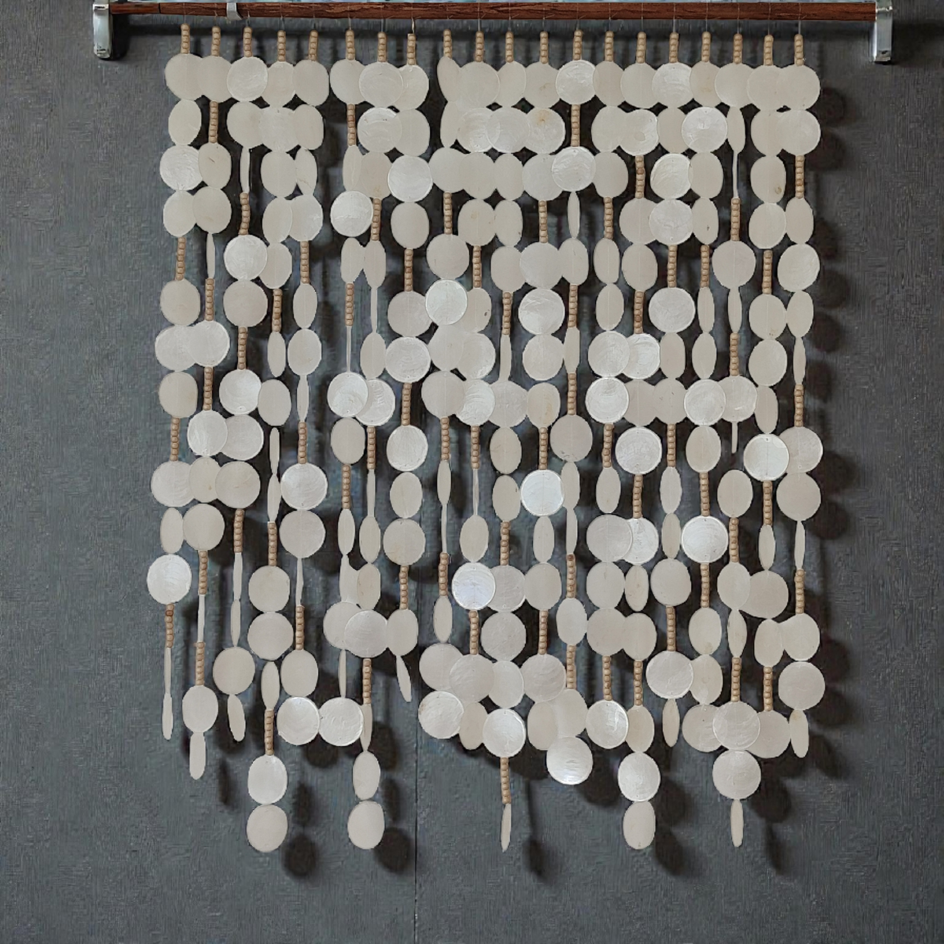 Capiz shell wall hanging decor hanging on grey wall