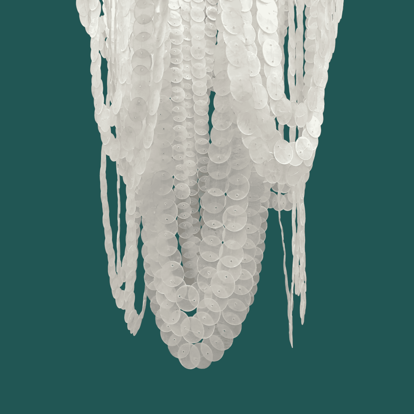 White capiz shell chandelier against a teal background