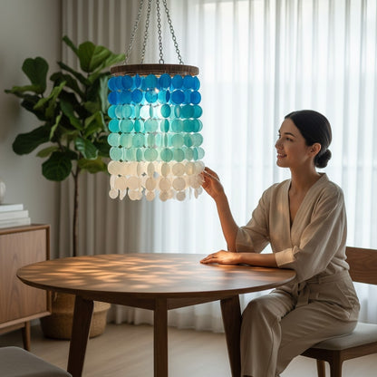 Woman adjusting a colorful pendant light in a modern living room.