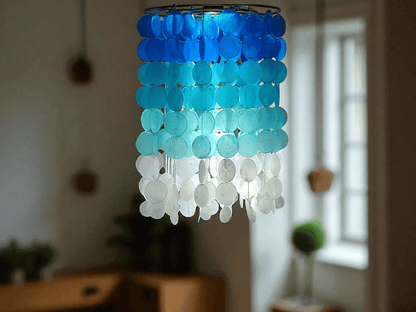 Blue and white chandelier hanging in a room with blurred background