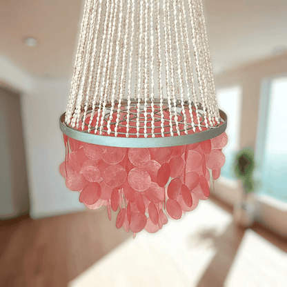 Chandelier with pink and silver design in a room with a blurred background