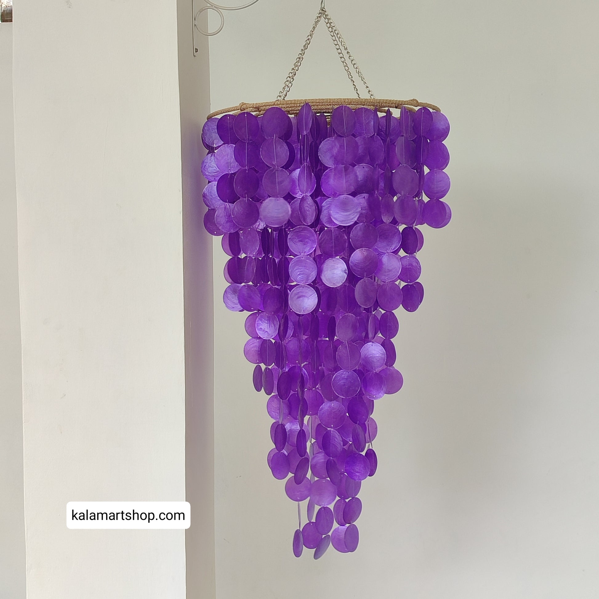 Purple capiz shell chandelier with a chain on a white background