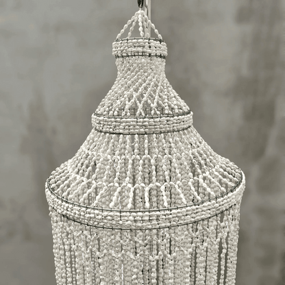 Decorative seashell chandelier against a neutral background