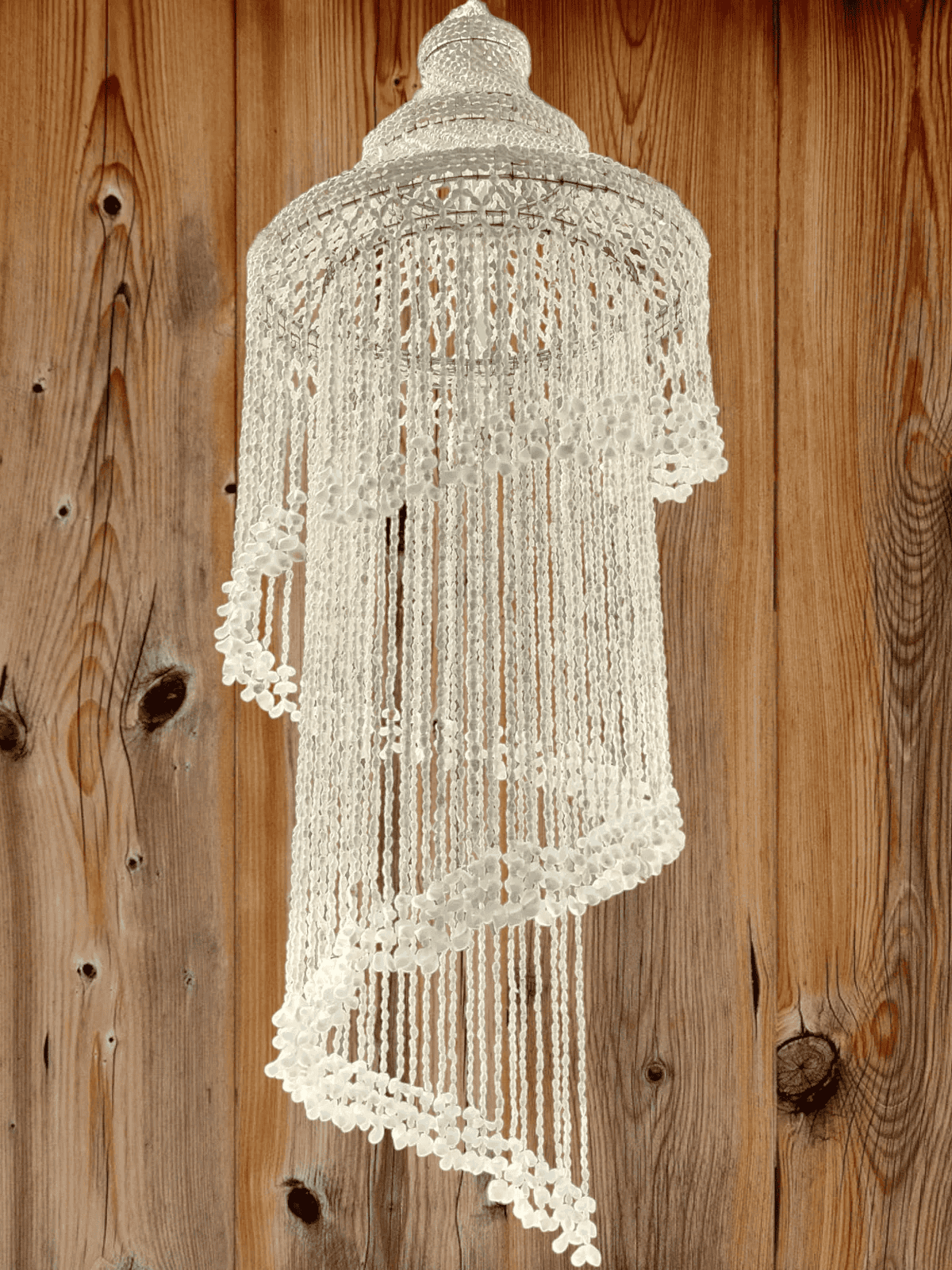 Seashell chandelier against a wooden background