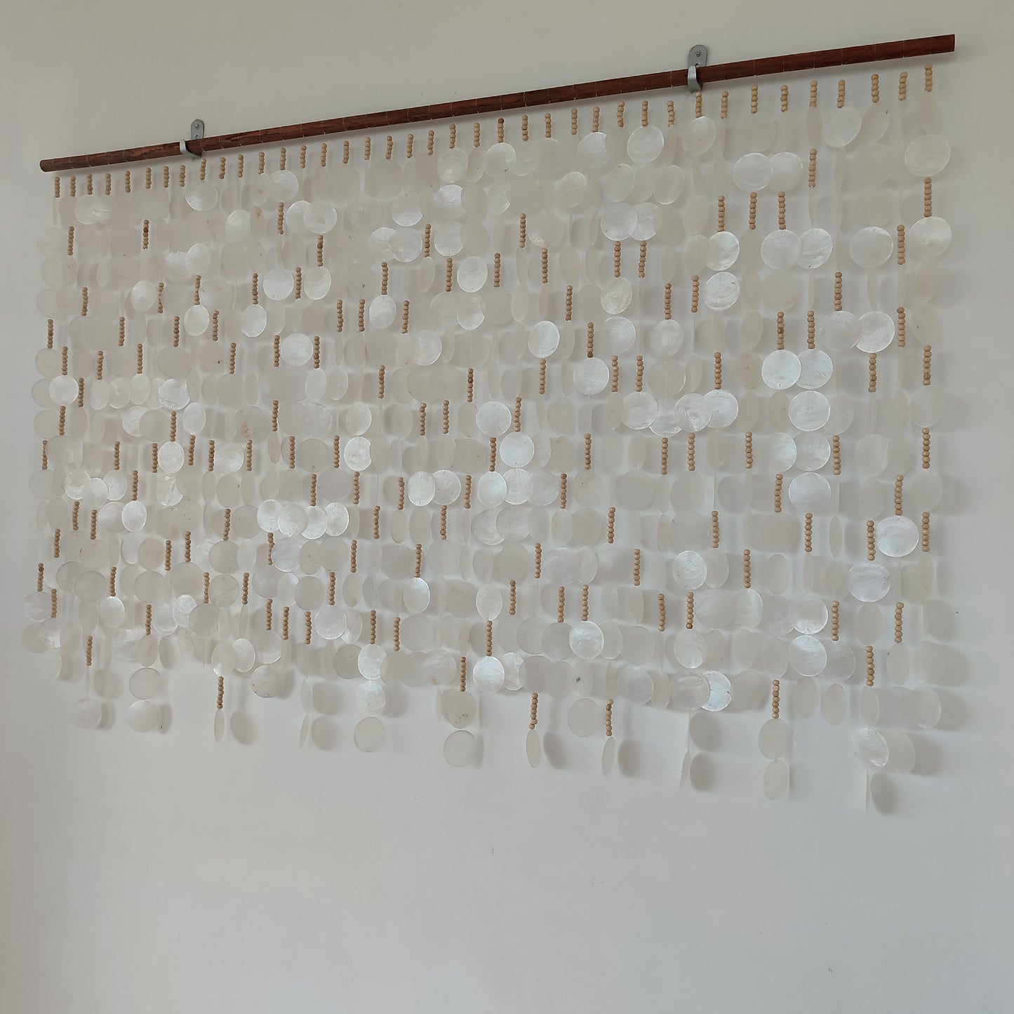 Capiz shell wall hanging on white wall