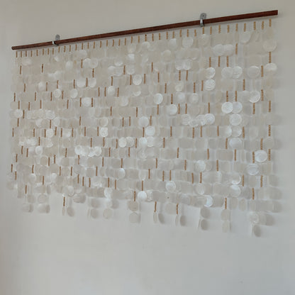 Capiz shell wall hanging on white wall